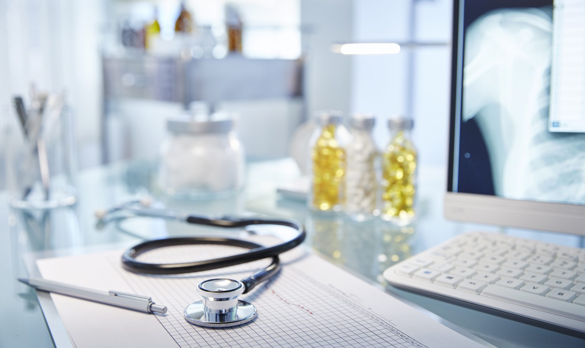Patient chart and stethoscope on a clinician’s desk.